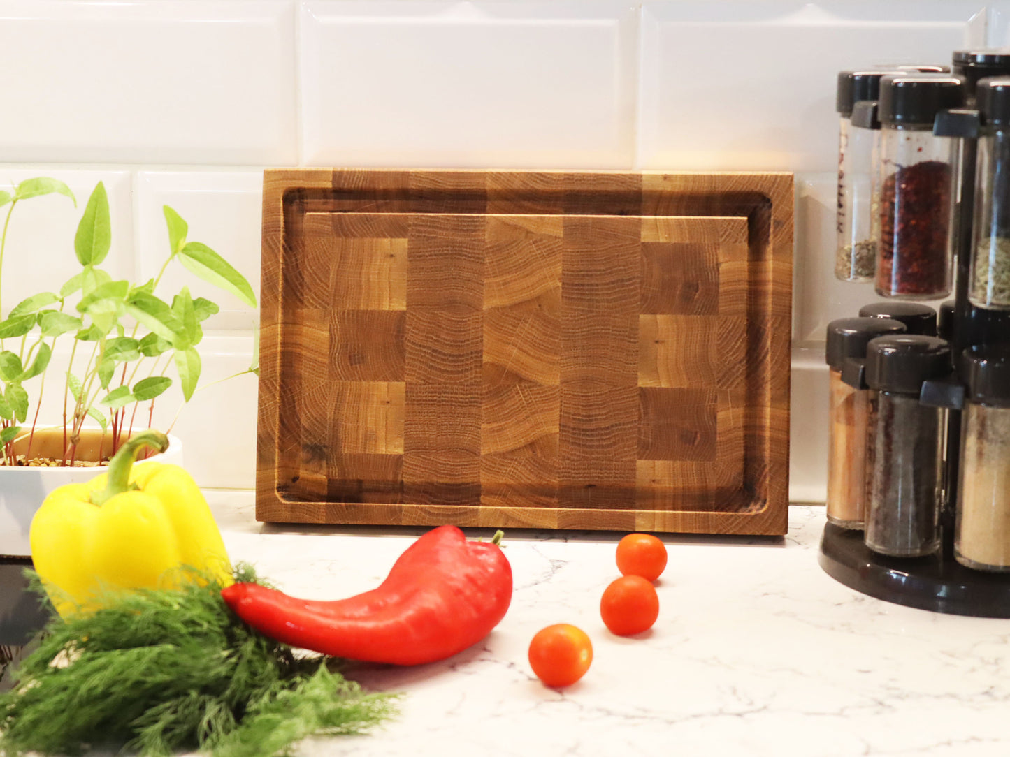 Exclusive end grain cutting board with a juice groove