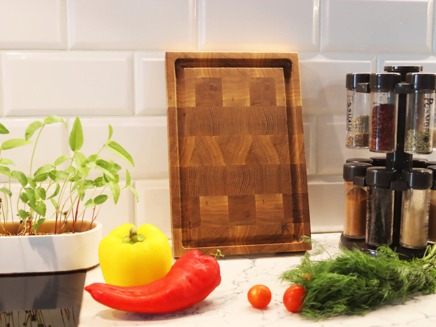 Exclusive end grain cutting board with a juice groove