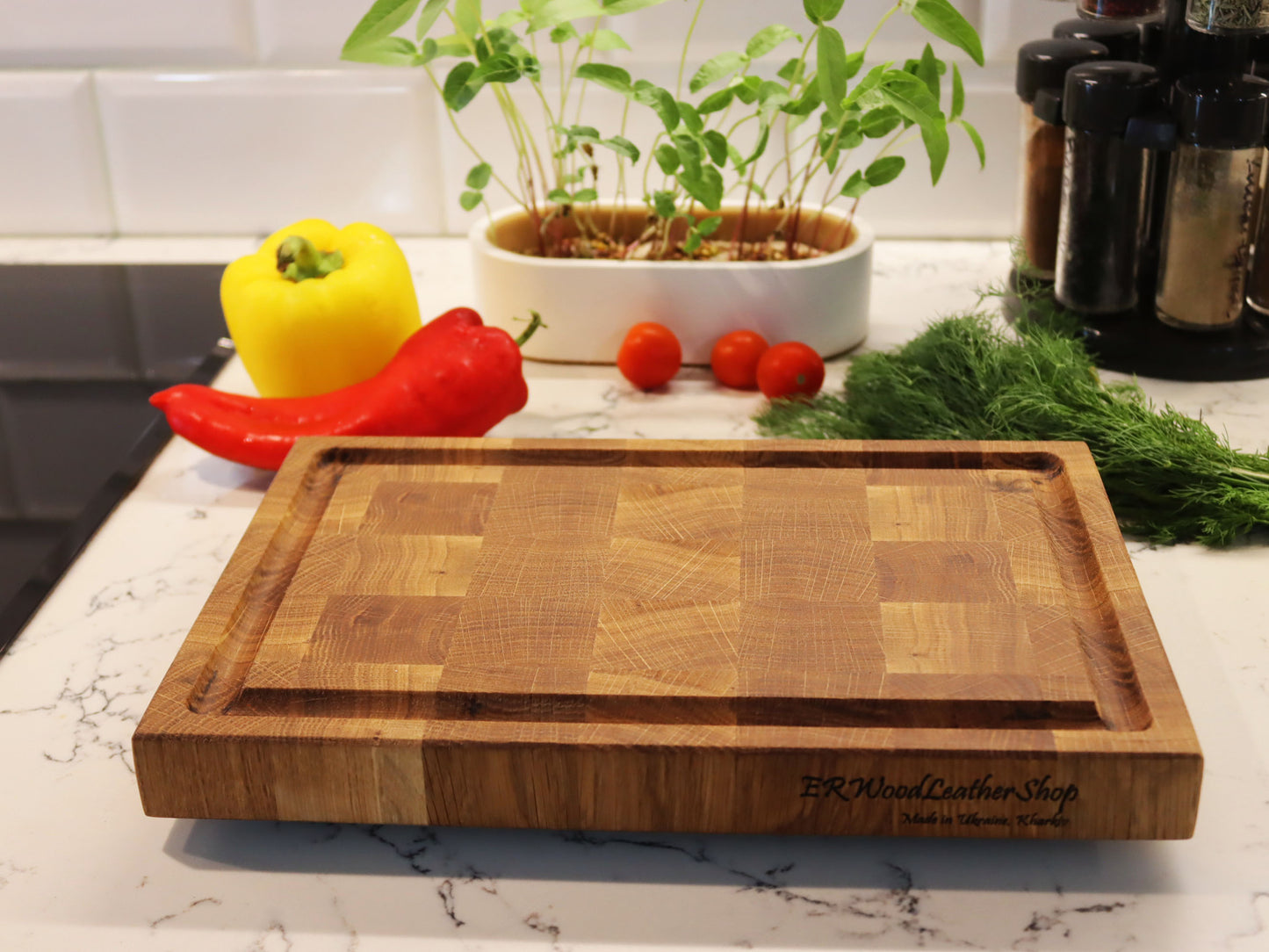 Exclusive end grain cutting board with a juice groove