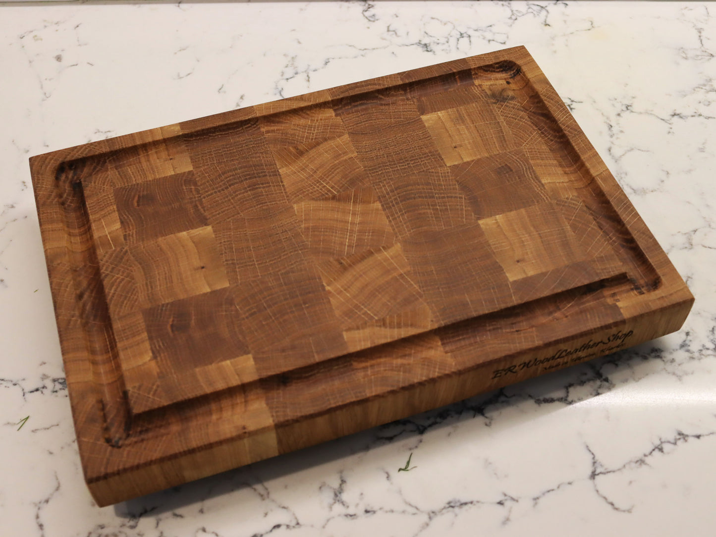 Exclusive end grain cutting board with a juice groove