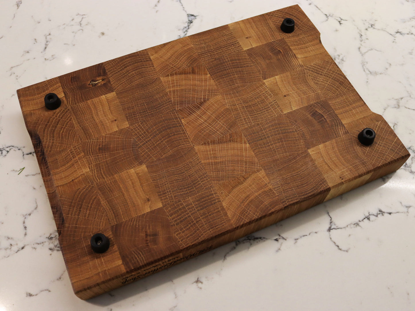 Exclusive end grain cutting board with a juice groove