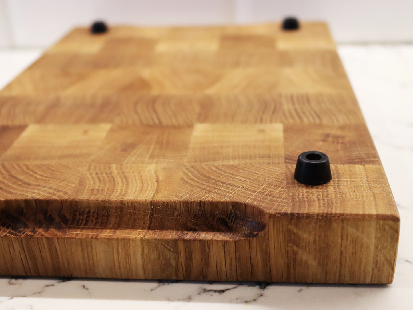 Exclusive end grain cutting board with a juice groove