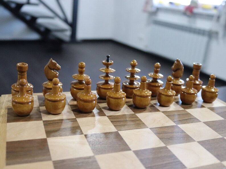 Reproduction of tsarist russia roly poly chess pieces with chessboard